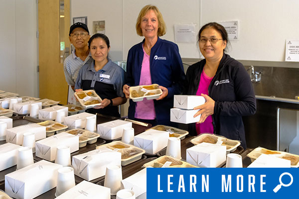 rec staff smiling at senior meals event, click to learn more